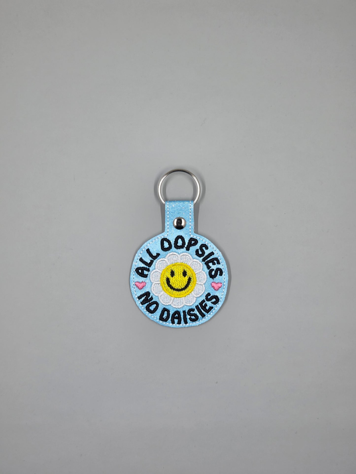 “All Oopsies No Daisies” Embroidered Keychain | Vinyl Smiley Flower Keychain