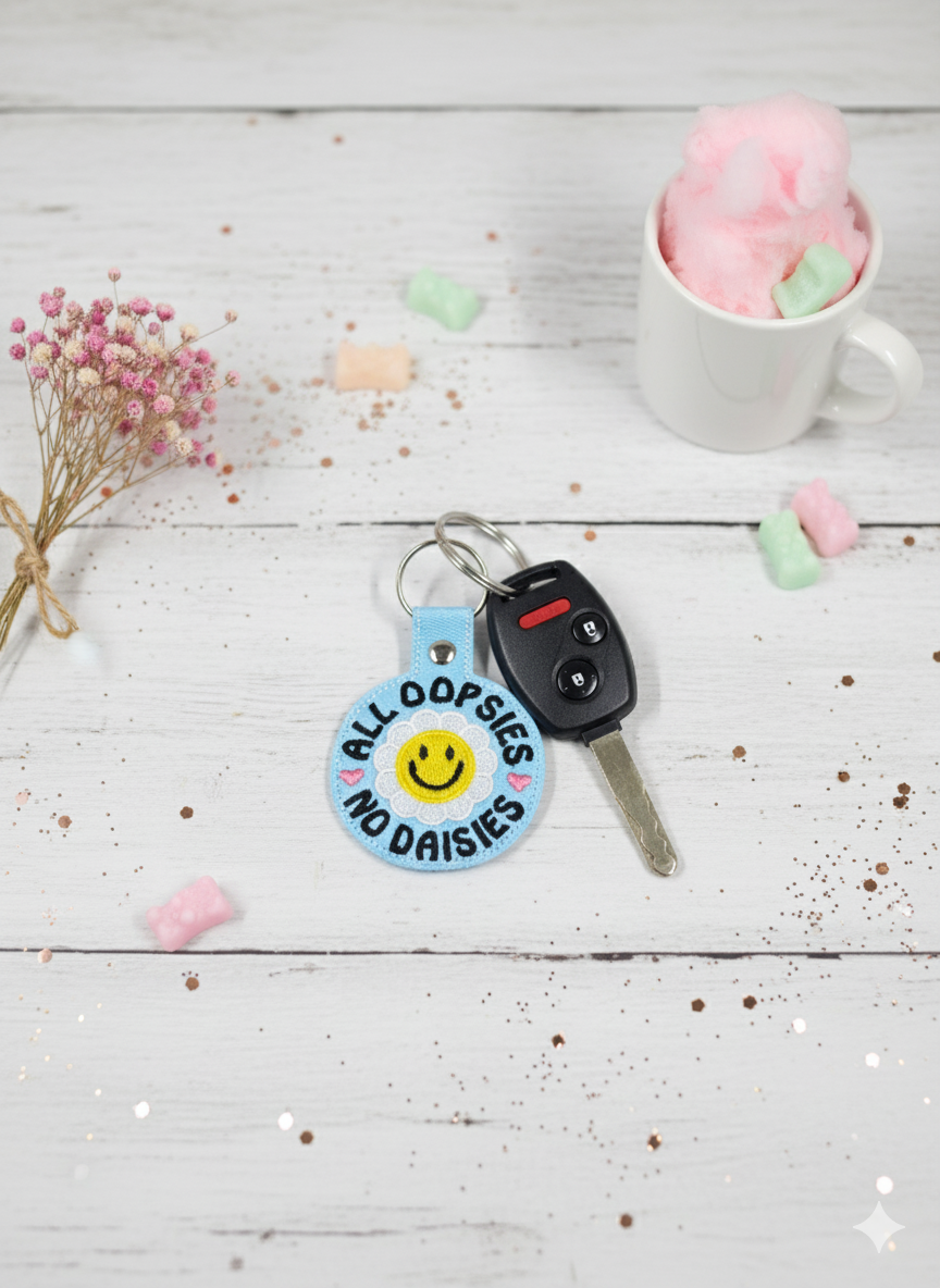 “All Oopsies No Daisies” Embroidered Keychain | Vinyl Smiley Flower Keychain